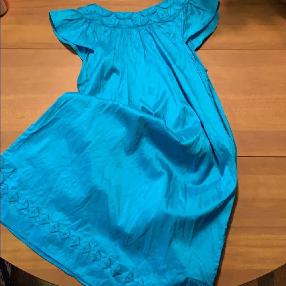 Teal dress with detail at the neck and bottom